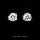 A pair of white gold diamond stud earrings of 70 points