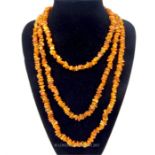 A long, rough amber bead necklace