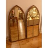 A pair of painted metal framed Gothic arched garden wall mirrors, 122 cm h