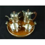 An Art Deco Walker and Hall EPNS four piece tea set together with an Art Deco circular walnut and