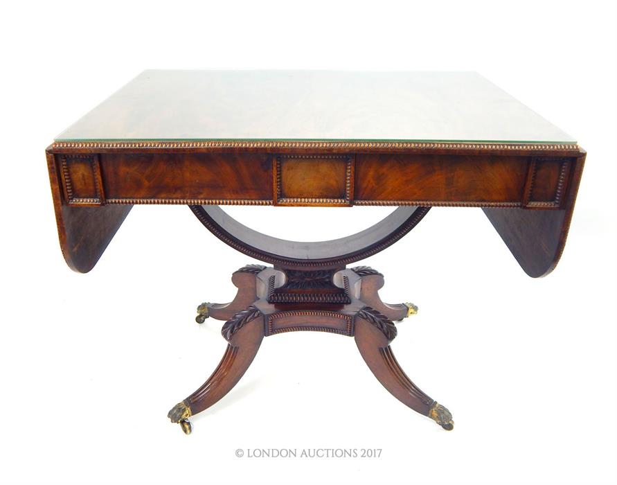 A Georgian rosewood sofa table; with bowed support fitting to is base; 143cm wide (fully