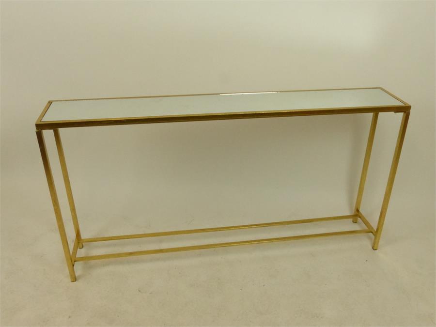 A mirror topped side table with gilt metal frame.