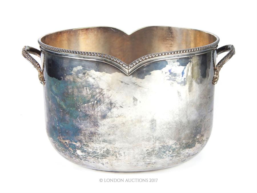 A silver plated Christian Dior ice bucket of oval form, having a beaded border and twin handles