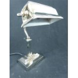 A contemporary chrome bankers desk lamp.