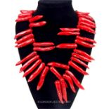 A very large, chunky, blood- red coral necklace with silver clasp
