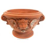 A terracotta planter; 29cm high.