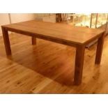 A fine and contemporary American made and designed large teak table, in a natural finish; 220cm