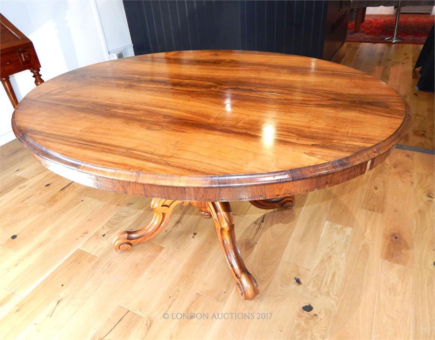 A fine quality Georgian rosewood tilt top table raised upon a quadraform base; top 145 cm oval.