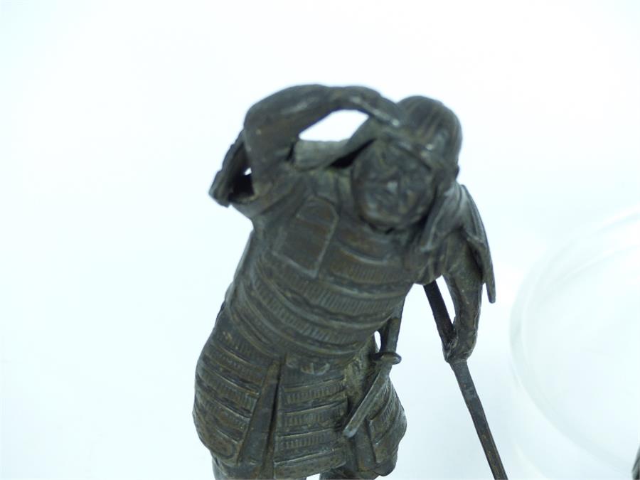 A Japanese bronzed spelter figure of a samurai warrior holding an axe and staring into the distance, - Image 2 of 3