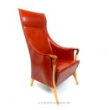 A Giorgetti red leatherette upholstered armchair.