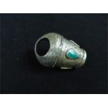 A large Bedouin seal ring of white metal inlaid with green stone (8.5cm high) together with four