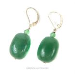 A pair of large, green jade drop earrings on sterling silver fittings
