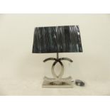 A Chanel style polished steel table lamp with shade