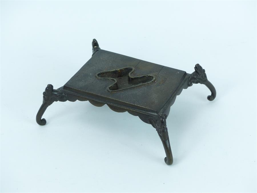 A Chinese bronze rectangular display stand raised on four elephant head supports