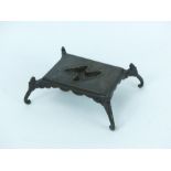 A Chinese bronze rectangular display stand raised on four elephant head supports
