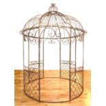 A large distressed finish metal garden gazebo of cylindrical form