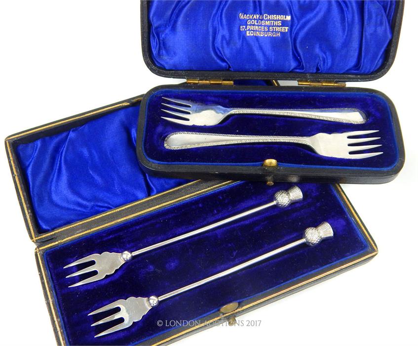 Two cased pairs of sterling silver pickle forks