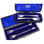 Two cased pairs of sterling silver pickle forks