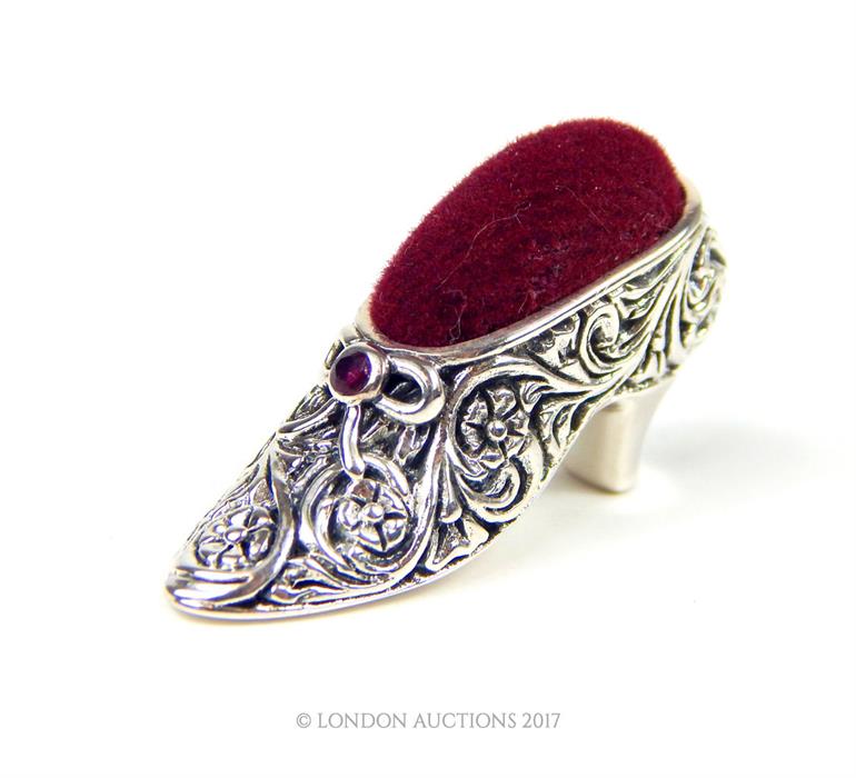 A silver pin cushion in the form of a lady's shoe