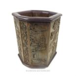 A Chinese bamboo octagonal brush pot, carved with figures amongst landscapes