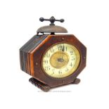 An oak cased alarm clock with Arabic dial.