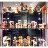 A large collection of beer tankards, mainly hand painted German stoneware