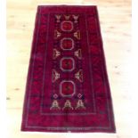 A Turkoman rug with four medallions on a red field