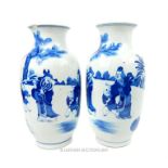 A pair of Chinese blue and white vases each with a four character mark to its base; 38.5cm high.
