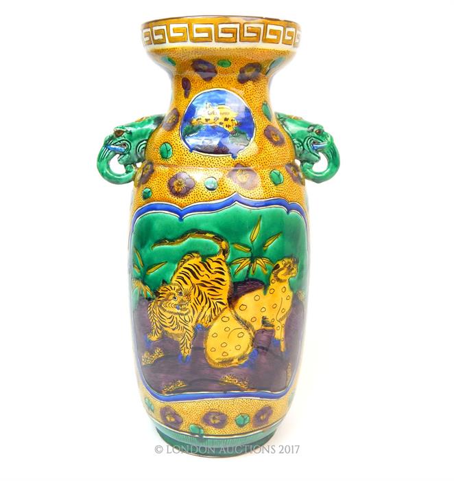 An eastern twin, elephant headed, handled vase with a depiction of a leopard and tiger, yellow