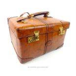 An Arfango Italian tan leather vintage style travel vanity case with brass fittings