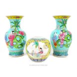 A pair of Chinese famille rose porcelain vases decorated with figures on a turquoise ground