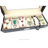 Black jewellery box displaying six sterling silver and semi-precious stone necklaces