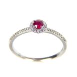 An 18ct white gold ruby and diamond cluster ring; size L/M.