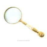 A large brass magnifying glass with mother of pearl handle; 25cm long.