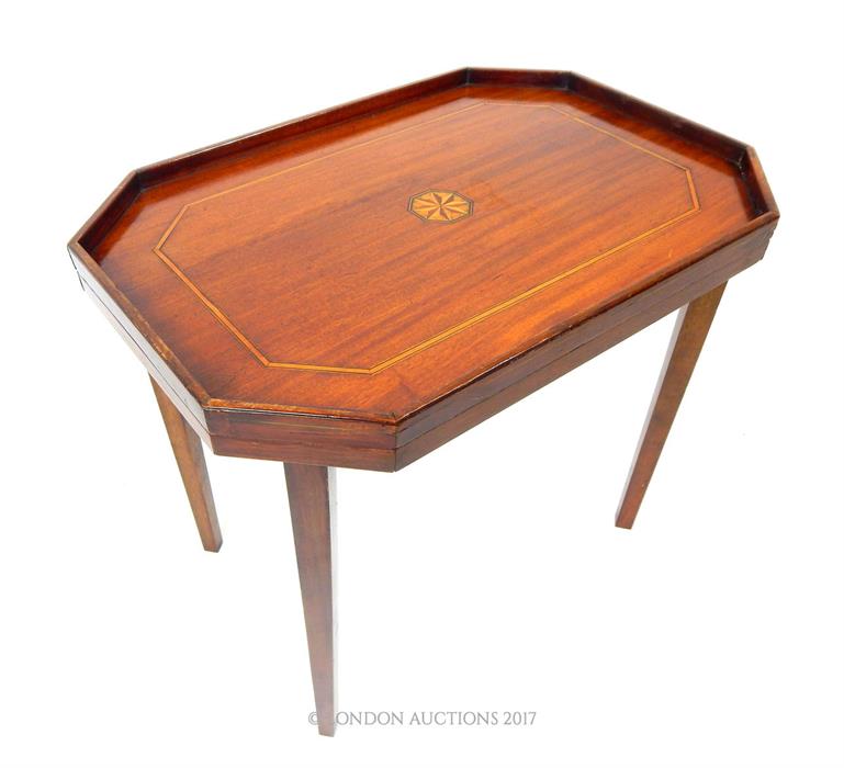 An inlaid mahogany occasional table of rectangular form with canted corners