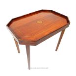 An inlaid mahogany occasional table of rectangular form with canted corners