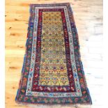 A hand made Persian runner with repeating motifs of a yellow field
