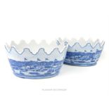 A pair of blue and white porcelain planters of oval form with crenelated rim