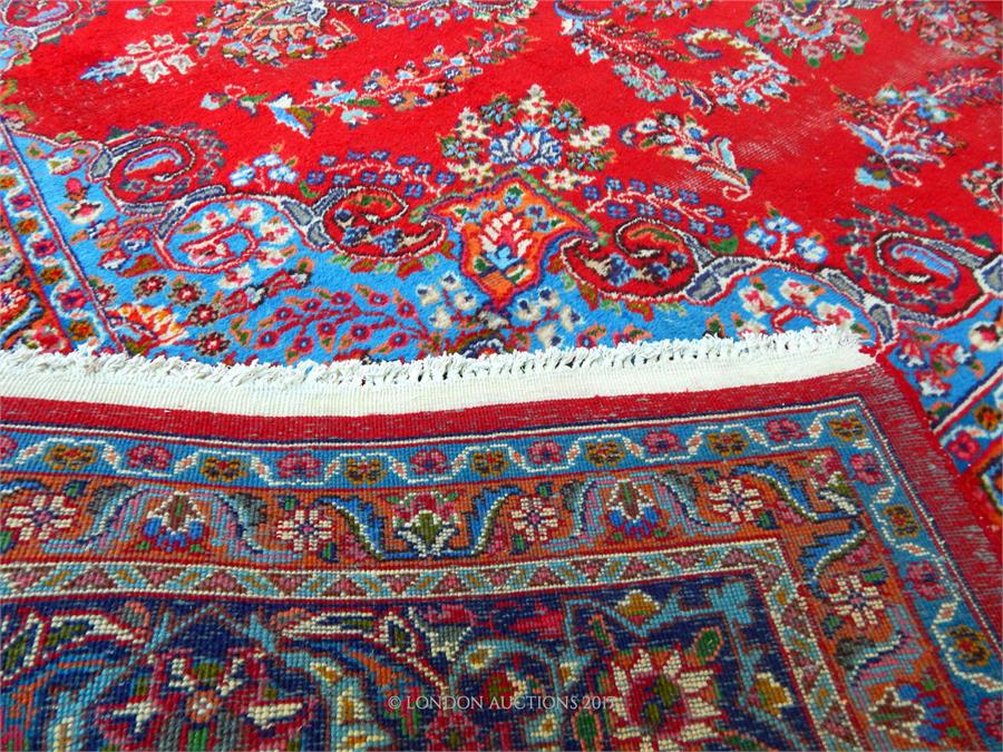A Persian Isfahan carpet, having a medallion on a red field with spandrels - Image 3 of 3
