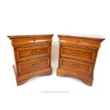 A pair of Continental cherrywood bedside chests having three drawers