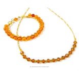 An amber and yellow metal bracelet of 21 beads, together with a necklace