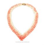 A vintage, beaded coral necklace with a silver gilt clasp