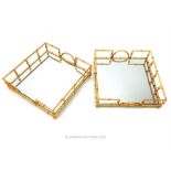 A pair of Oriental design square mirrored trays with gold coloured faux bamboo frames