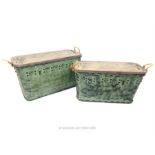 A graduated pair of painted and distressed metal trunks of luggage design