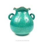 An Oriental crackle glazed twin handled vase, having a turquoise green glaze to the exterior