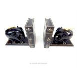 A pair of mid 20th century Ceylon hardwood bookends, in the form of elephants with bone tusks,