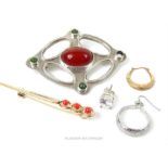 A collection of jewellery, including a white metal Arts & Crafts style brooch set with red agate