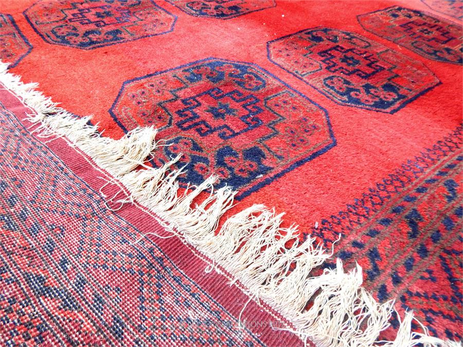 A Turkoman carpet, with large elephant foot motifs on a red field, surrounded by running borders, - Image 3 of 3