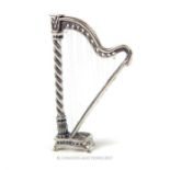 A cast silver miniature harp; 6cm high.
