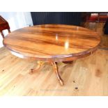A fine quality Georgian rosewood tilt top table raised upon a quadraform base; top 145 cm oval.